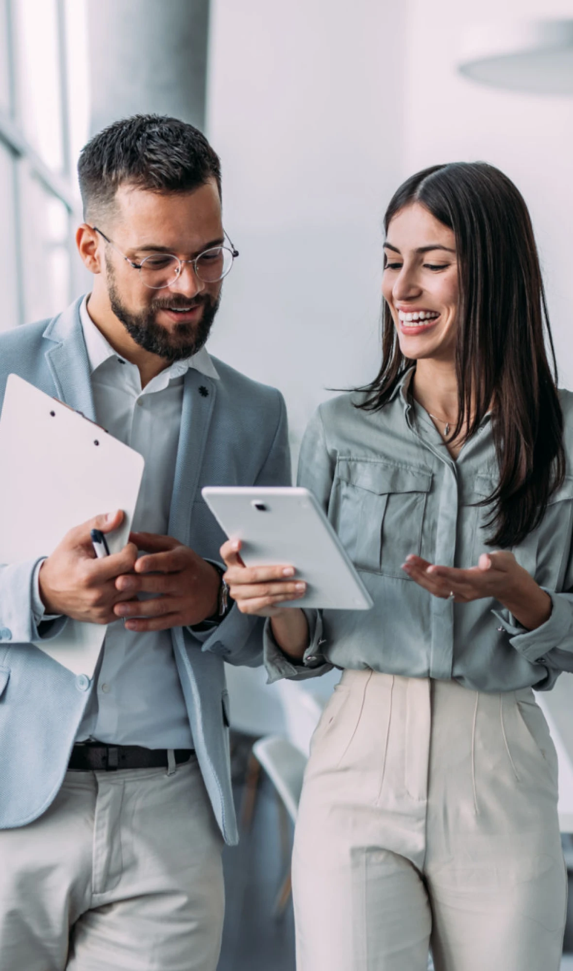 Colleagues discussing work on a tablet